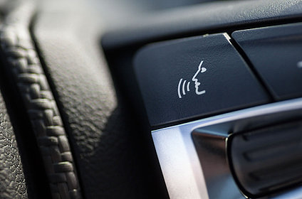 Steering wheel button with speech symbol